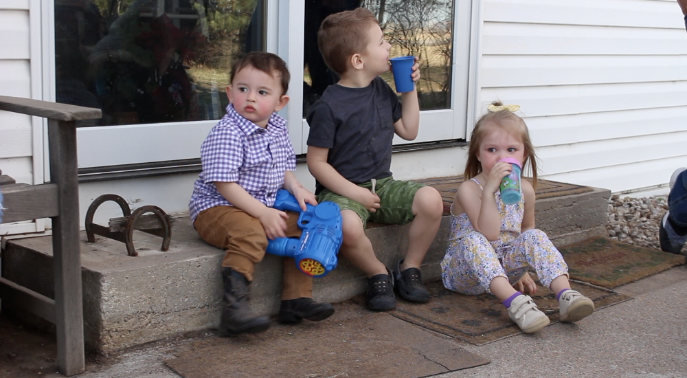 Aiden, Will, and Raegan taking a water break on the steps.