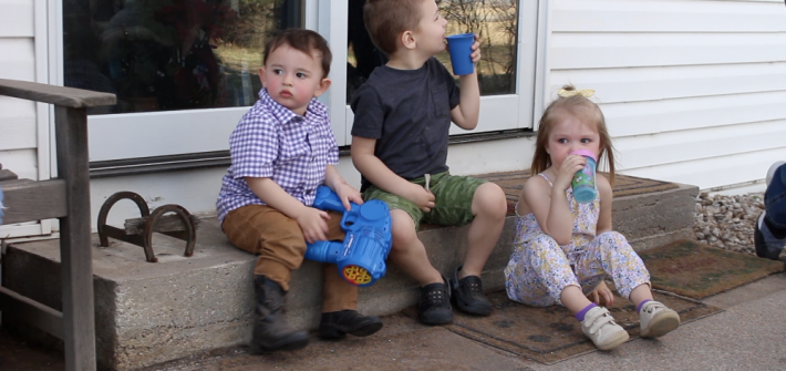 Aiden, Will, and Raegan taking a water break on the steps.